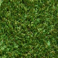 A close up shot of artificial turf designed for playgrounds featuring short green and brown grass strands